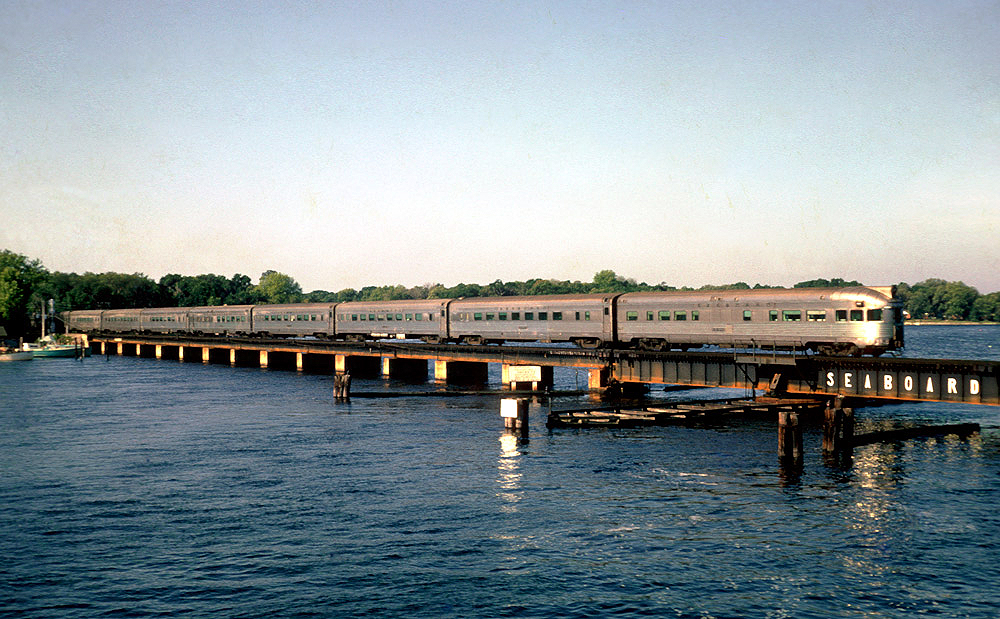 Stainless-steel streamliner crossing bridge.