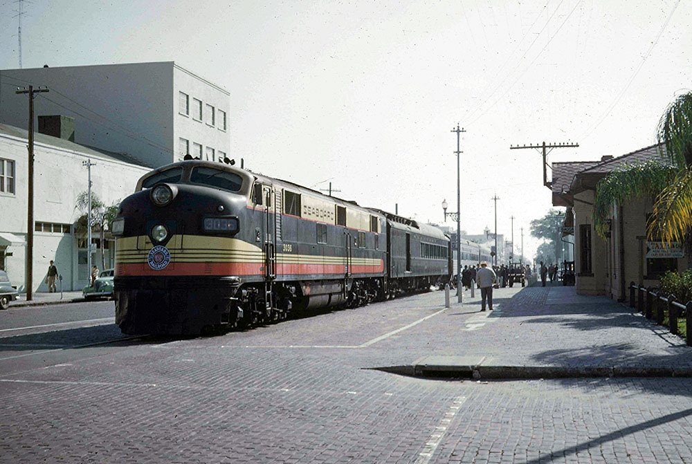 Streamlined diesel locomotives with passenger train at station .