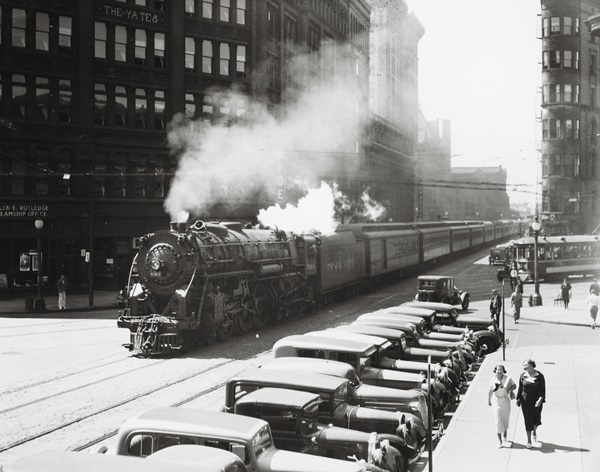 Hudson 5363 rolls down Washington Street in downtown Syracuse with an eastbound train. NYC passenger trains used this street trackage until a