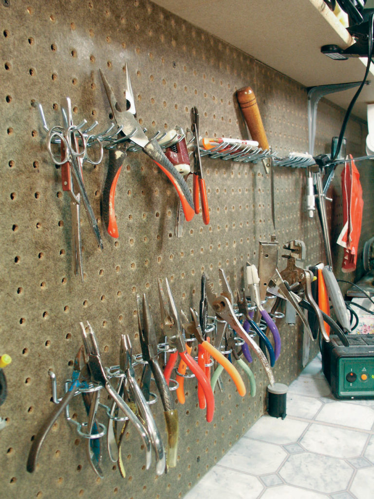 Hand tools within reach of a work bench.