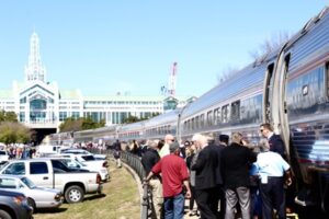 Train stopped while a crowd stands beside it