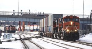 Train passing under a bridge in the winter