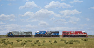 three locomotives in a row on tracks