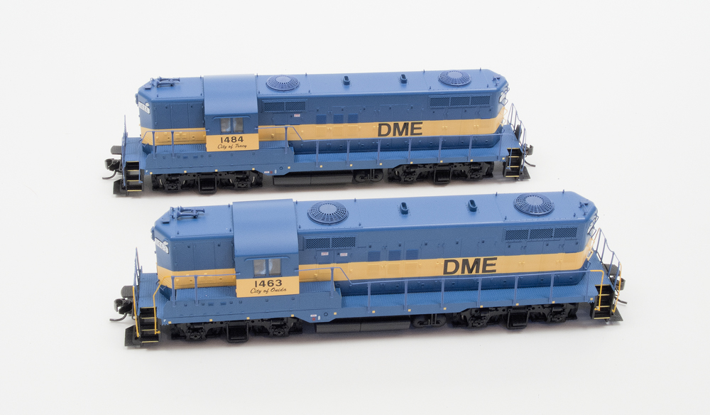 Walthers HO scale Electro-Motive Division GP9s with (foreground) and without vertical handrails painted yellow