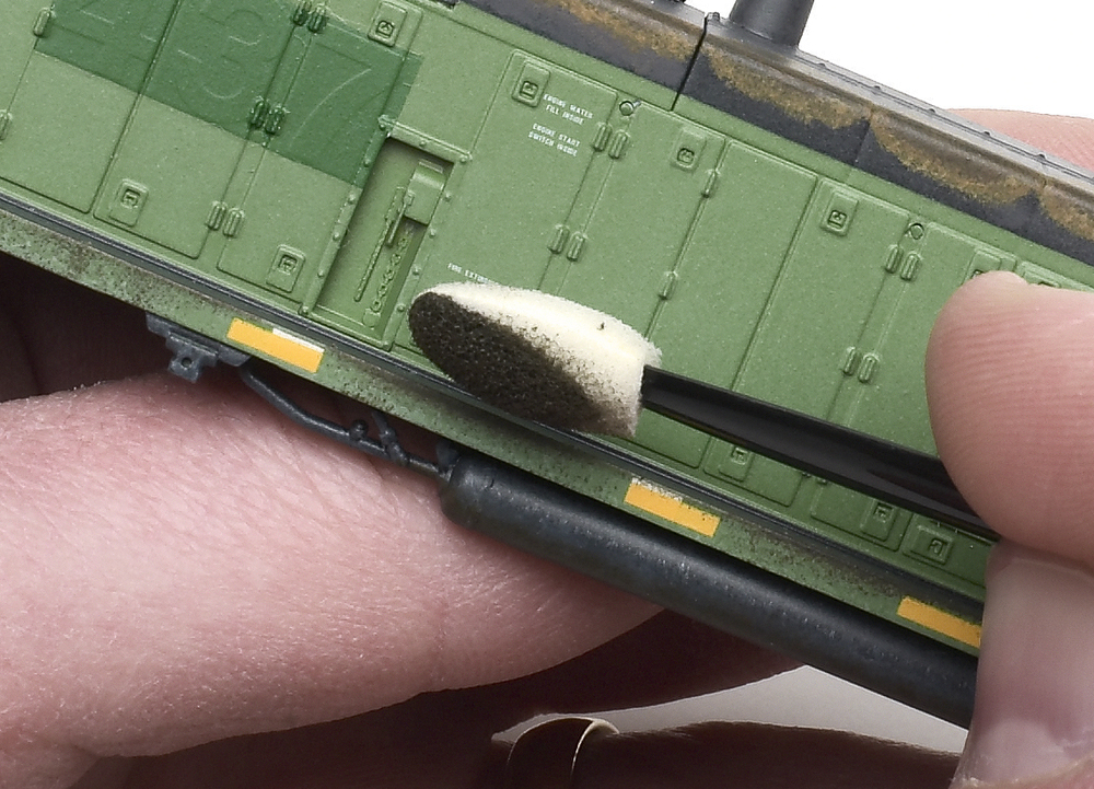 Applying Railroad Tie Brown acrylic paint to sill of SW1000 with makeup applicator.