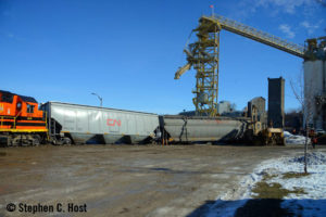 Derailed locomotive and grain cars by elevator