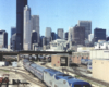 Amtrak passenger train on a bright and clear day with Chicago's skyline in the background.