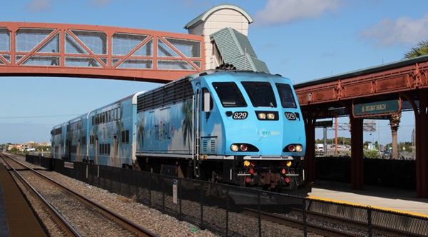 Light blue commuter rail train in station