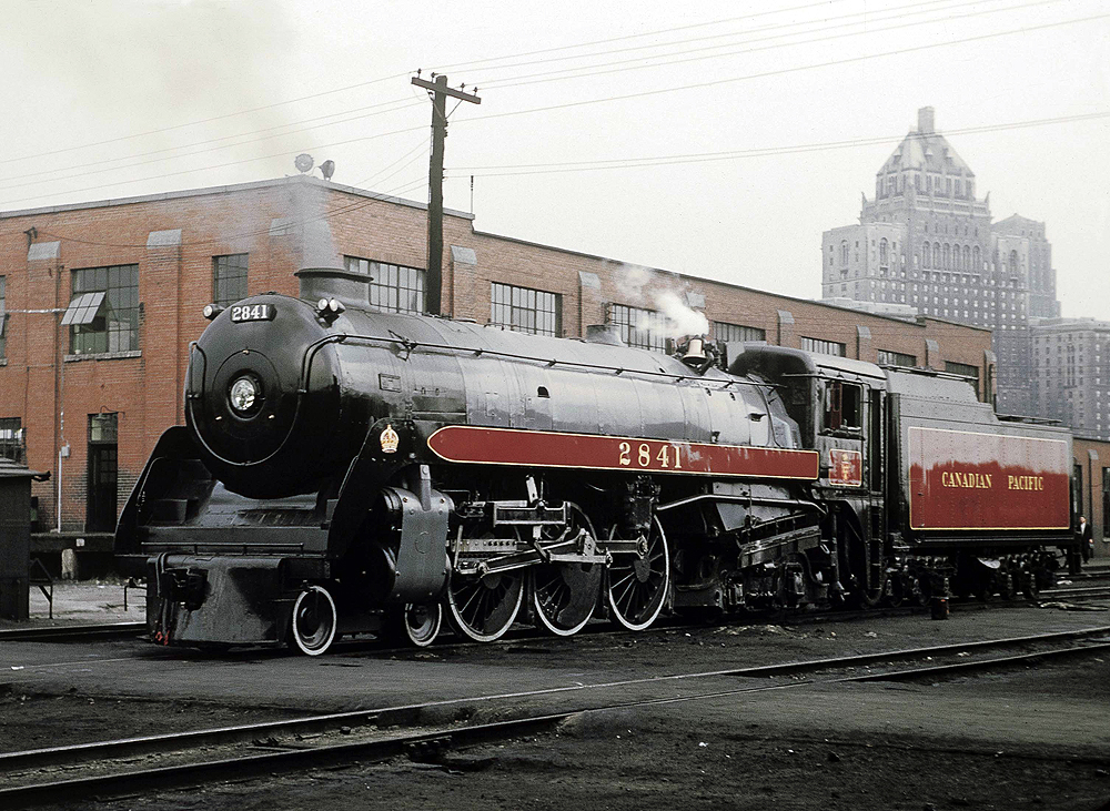 A semi-streamlined locomotive in a rail yard.