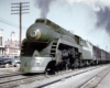 A green-painted locomotive with a nose headlight.