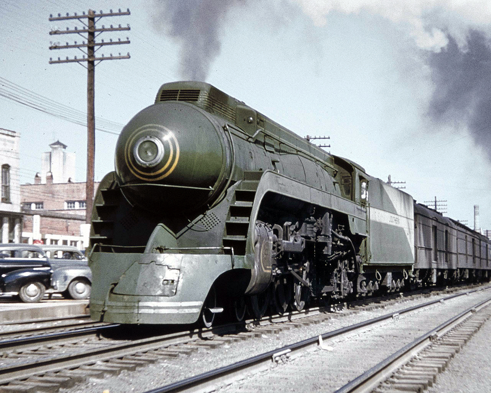 A green-painted locomotive with a nose headlight.
