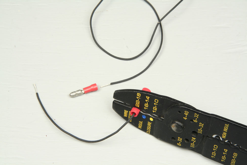 Making a wire harness by crimping male and female solderless connectors each to a length of 24-gauge stranded wire.