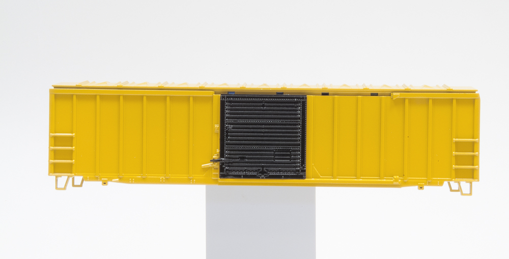 Yellow boxcar with black door after Clear Gloss finish has been applied.