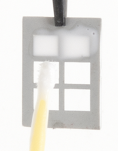 Using Microbrush to apply Microscale Kristal Klear to six-pane window.