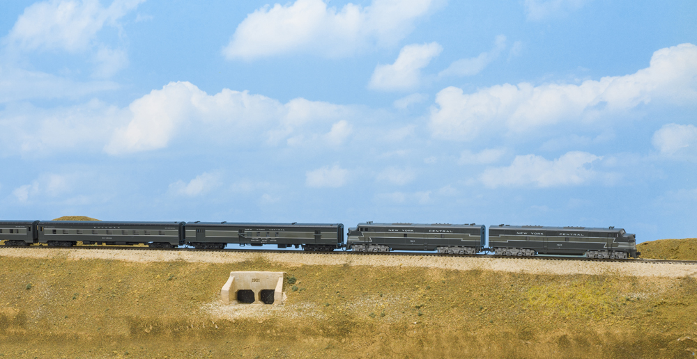 Train pulling a line of cars down the track