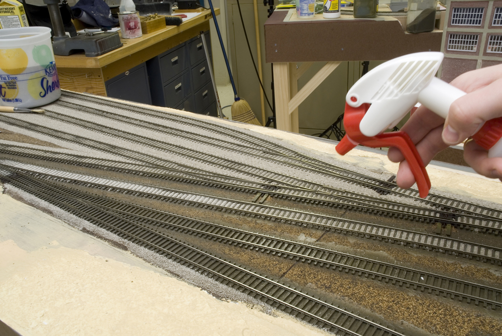 Wetting ballast with 70 percent isopropyl alcohol in a spray bottle.