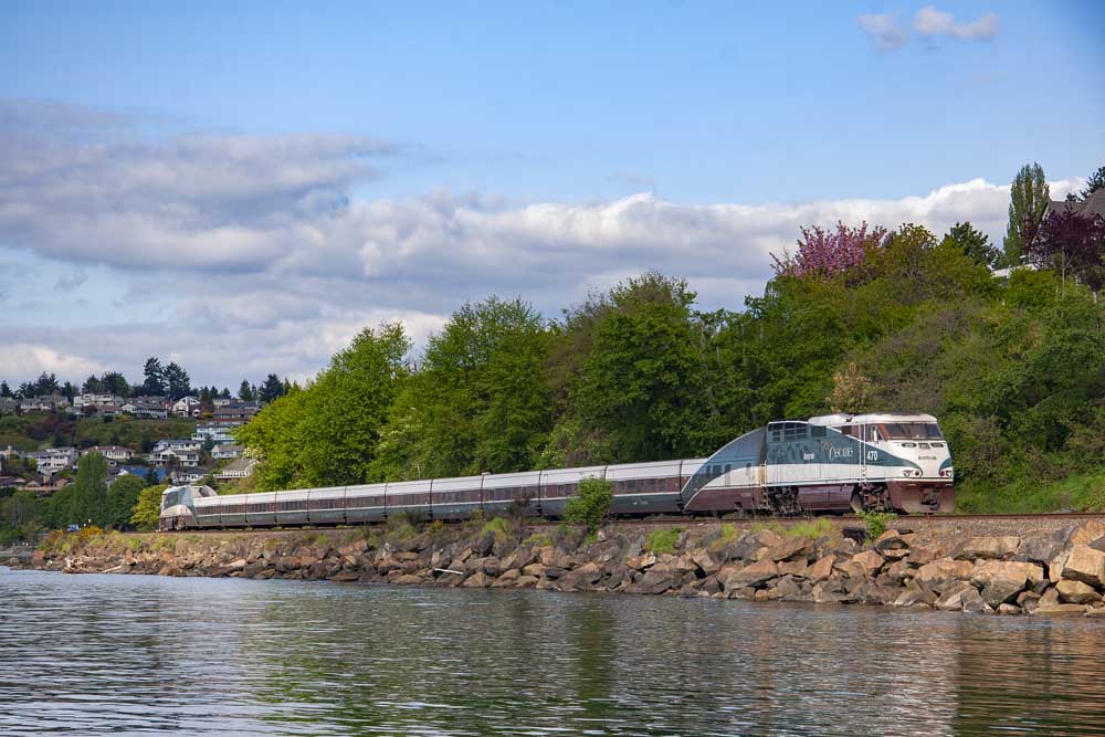 Passenger train along rocky coast line