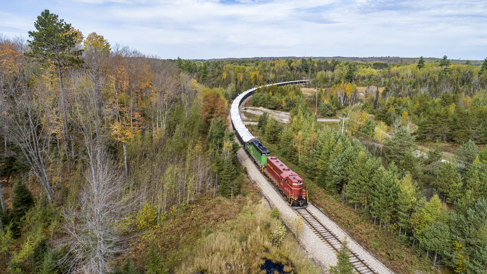 Red and Green Locomotives pulling a train