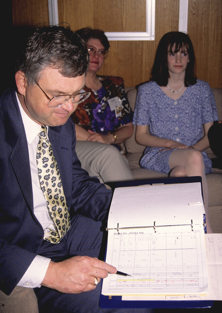 Man pointing to information in binder