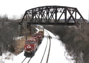 Train passing under a bridge in the winter
