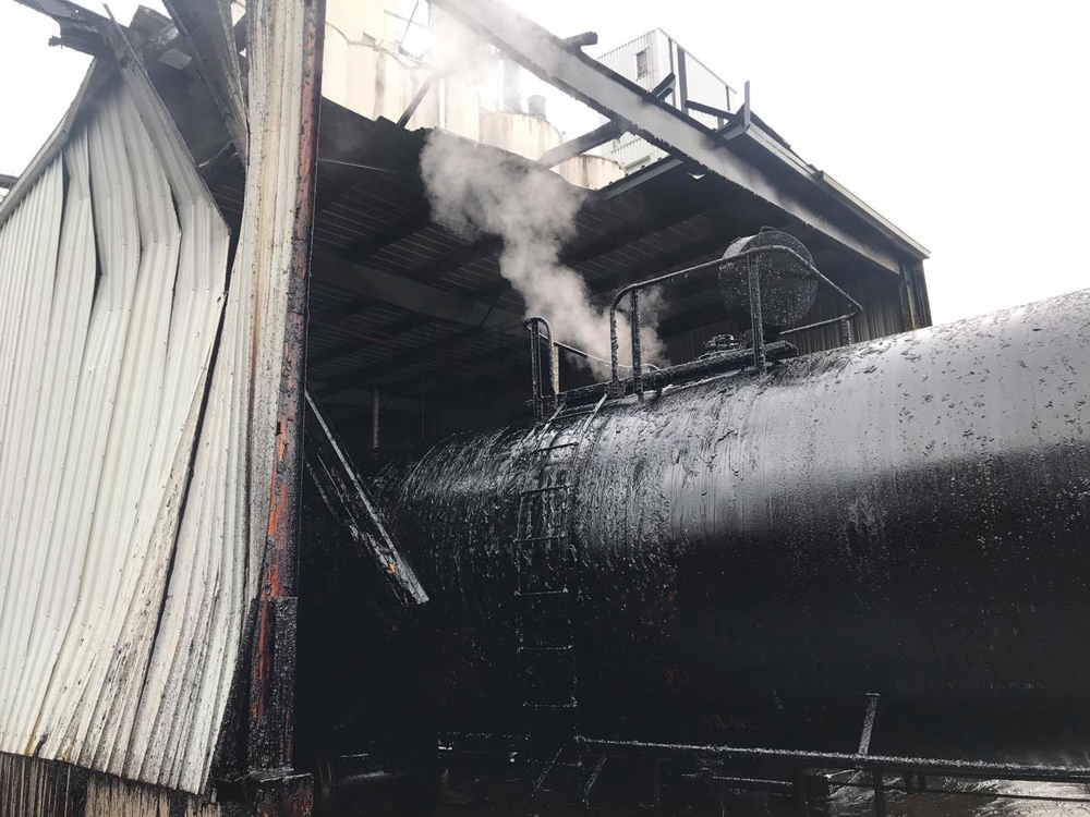 Tank car and damaged building