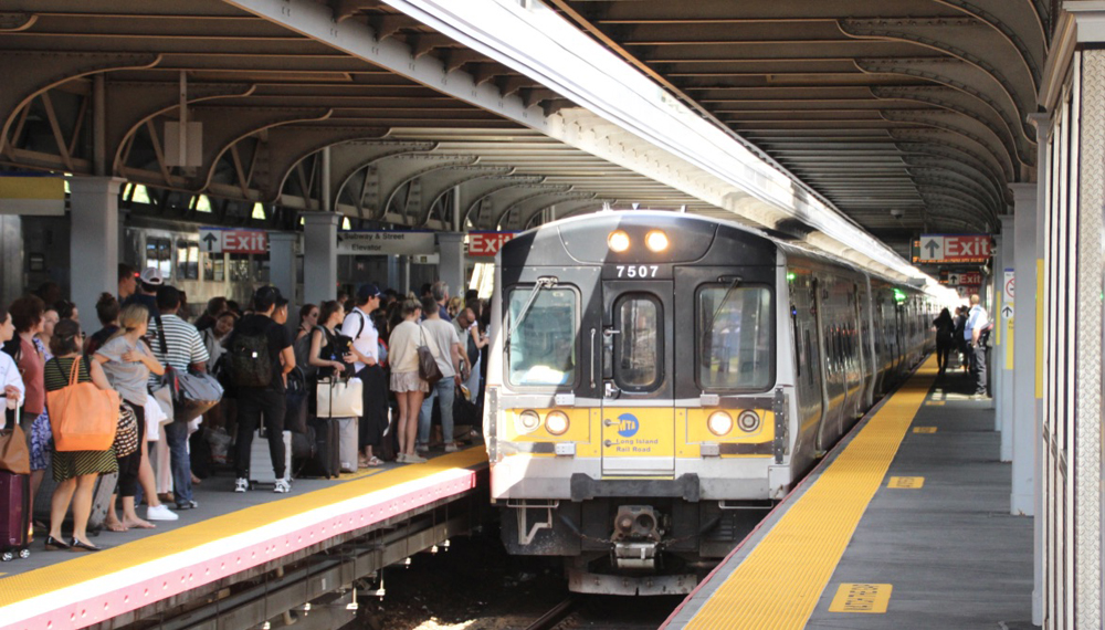 Long Island Rail Road train arrives at crowded station platform