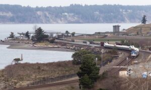 Train riding alongside a body of water