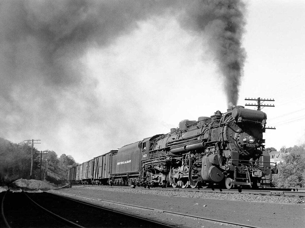 Steam locomotive produces smoke on fast train