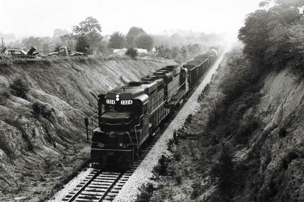 Diesel locomotives on coal train in cut