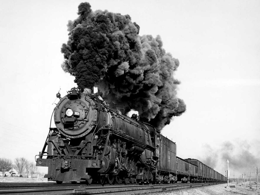 Steam locomotive smoking with freight train