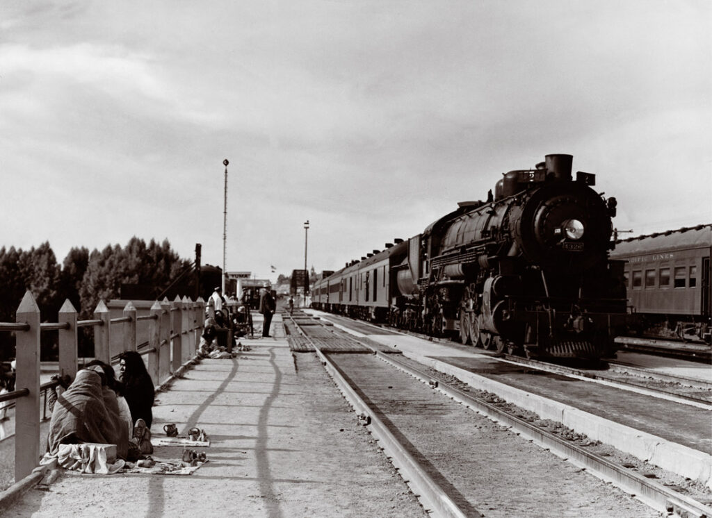 Steam locomotive with passenger train by station platform