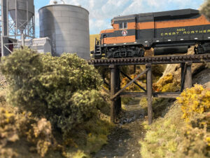 A model train passes over a bridge