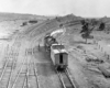 Overhead view of steam locomotive and caboose in freight yard