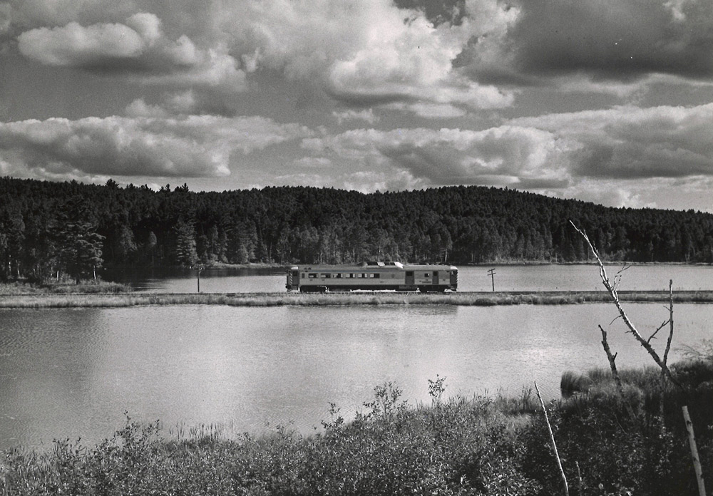 Rail Diesel Car on causeway over lake