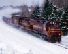 Three road-switcher diesel locomotives with freight train