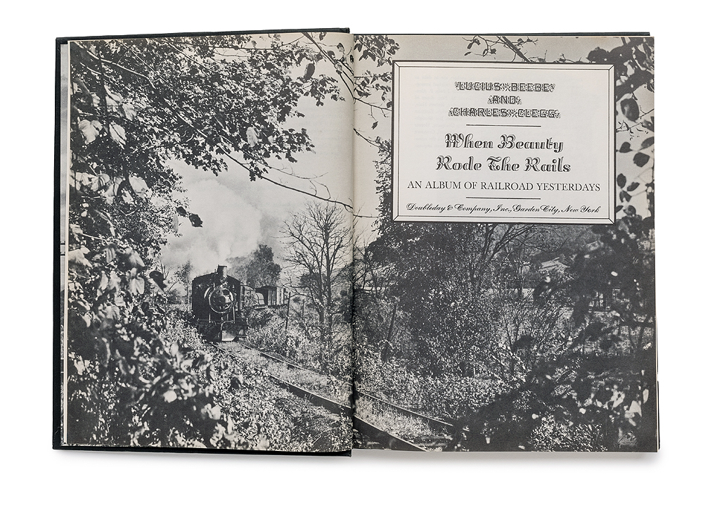 Title page featuring double-spread of a black and white steam locomotive in a tree-lined scene.
