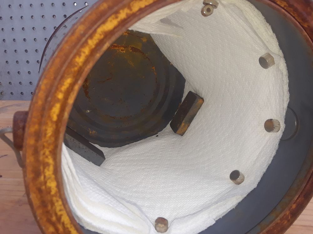 Metal paint can lined with paper towels and magnets