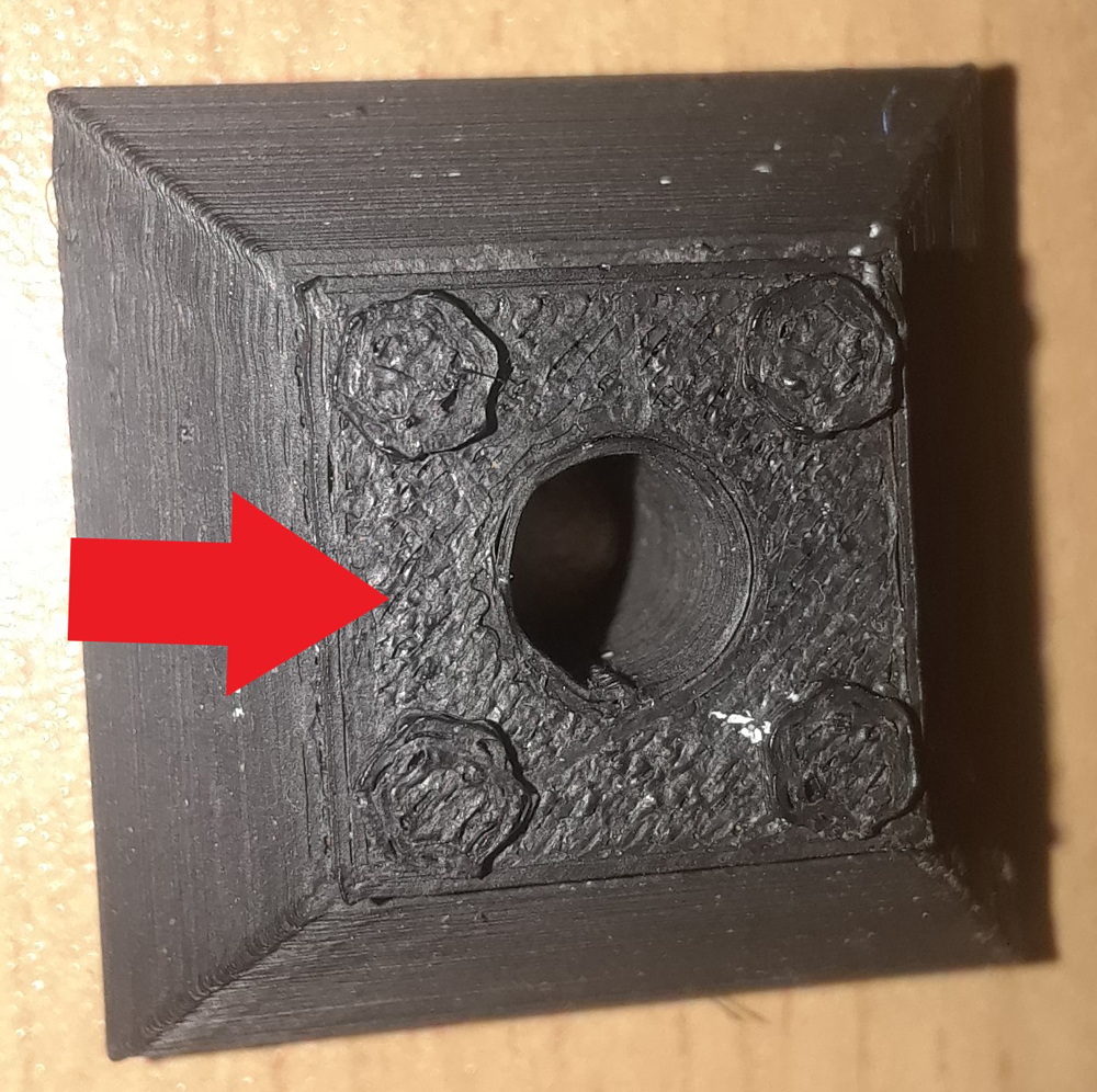 Arrow pointing to rough area on 3D plastic part.