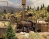 A weathered 2-8-0 steam locomotive rests in the engine servicing area while its crew takes a break