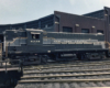 A diesel in New York Central’s two-tone gray lightning stripe scheme rolls onto a turntable