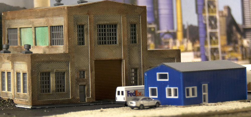 A fedex truck sits out in front of a warehouse