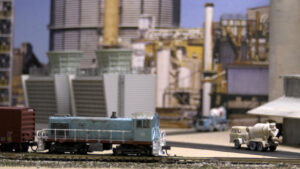 A locomotive sits parked in an industrial scenes