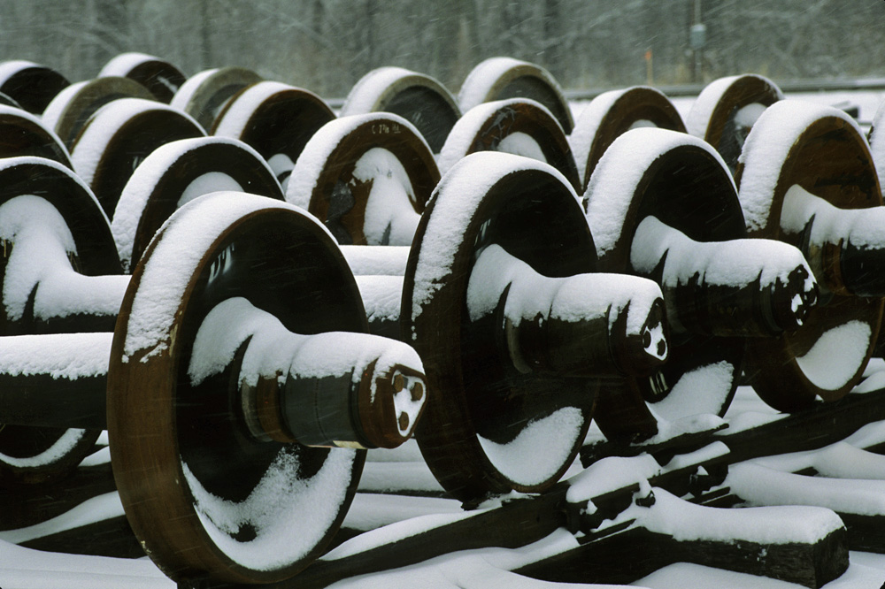 Spare car wheel sets in a Union Pacific yard accumulate snow during a snowstorm
