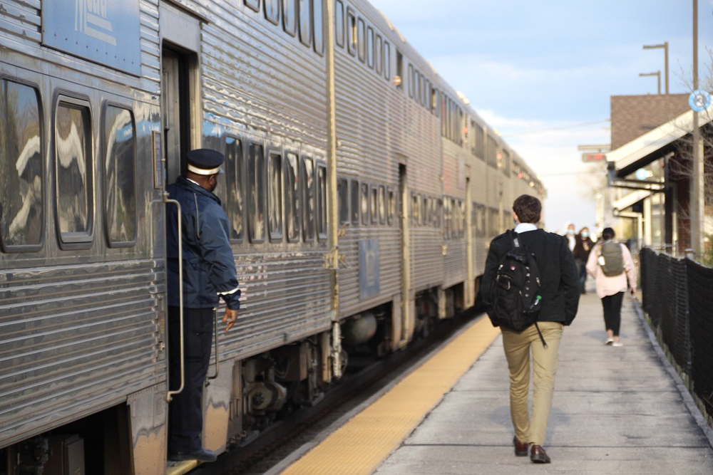 Passengers walking down platform after disembarking from commuter train