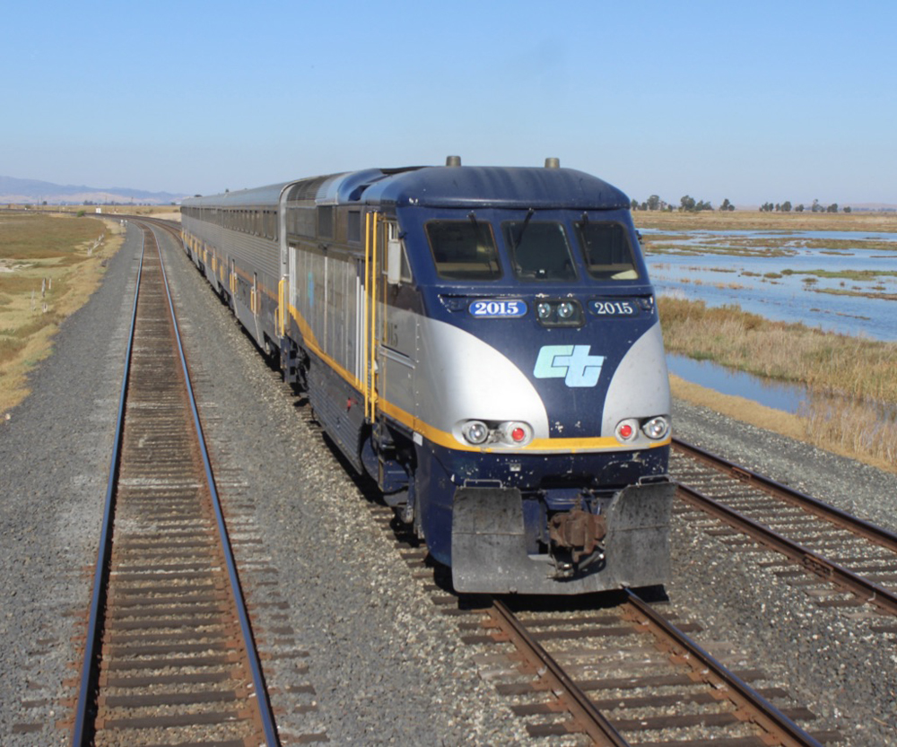 Passenger train approaches camera location.