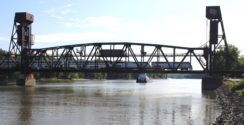 Train crossing river on lift bridge