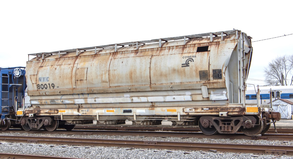 Rusting gray hopper car