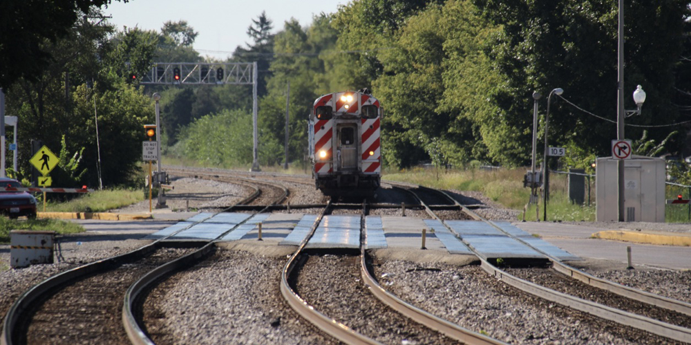 Commuter train approaching grade crossing