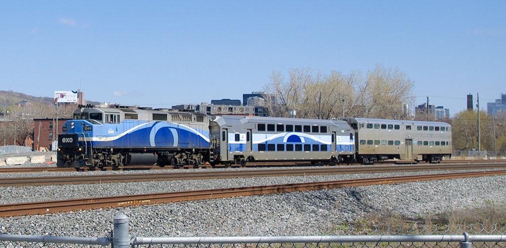 Locomotive pulling two commuter coaches