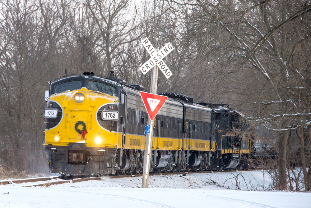 Train approaches grade crossing in snow